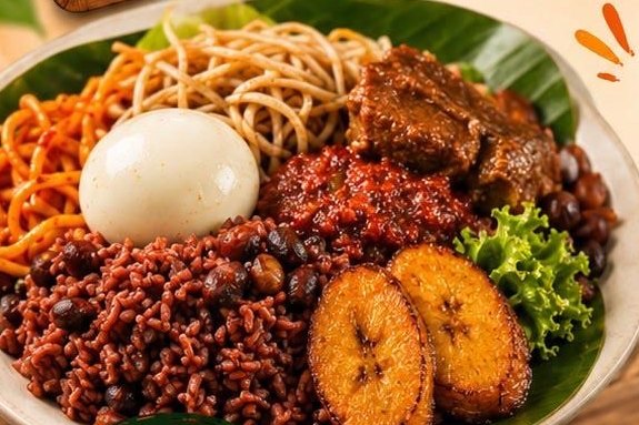 Waakye plate with egg, spaghetti, plantain and stew